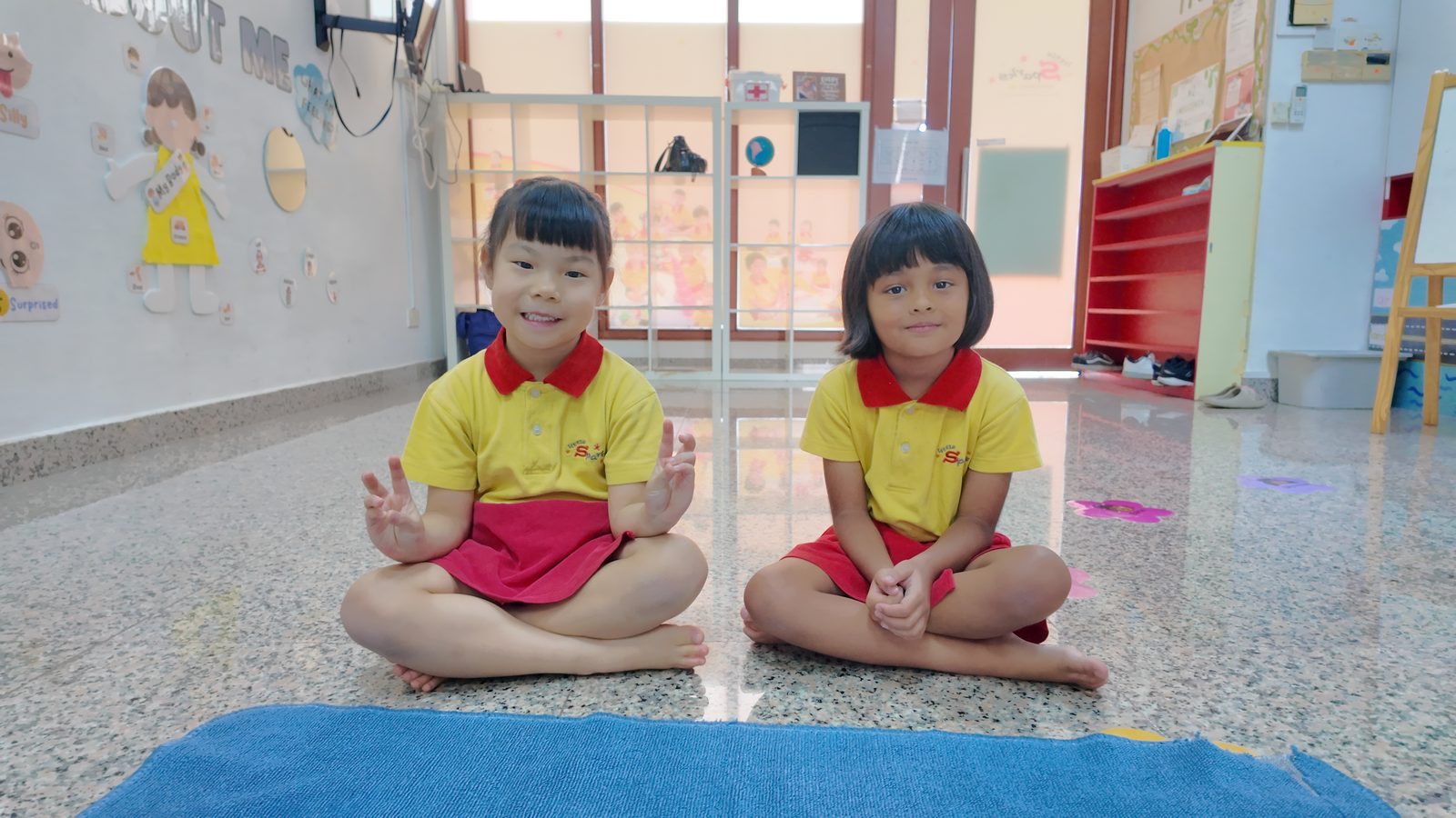 Two girls sitting uniform portrait