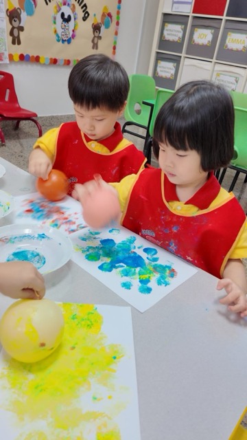 Two children painting side by side