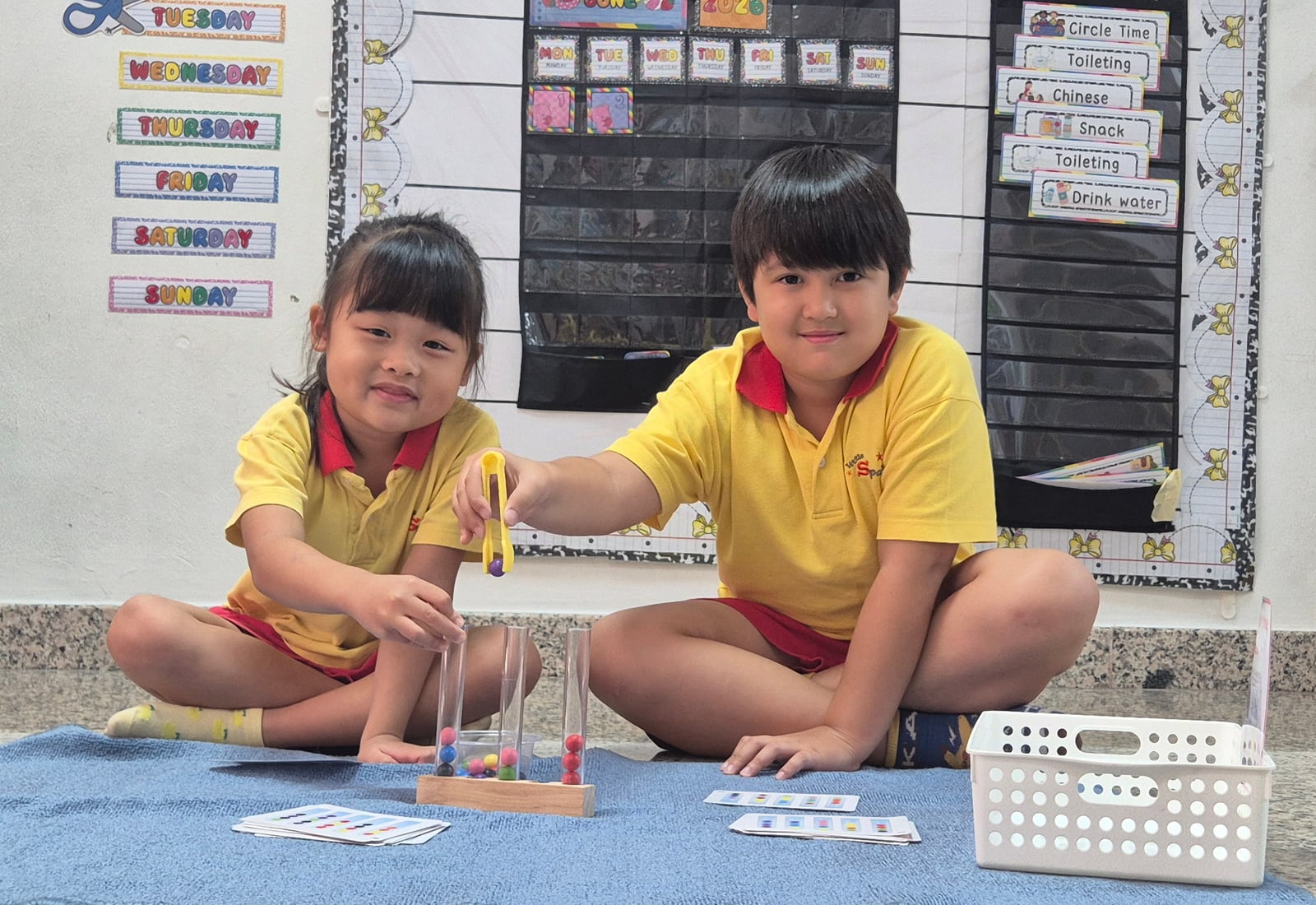 Kindergarten 2 children doing a Montessori counting activity